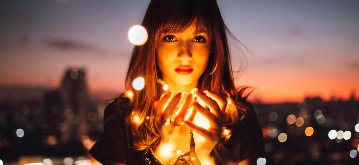 Woman with lights in her hands - a symbol of sexual empowerment