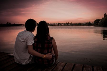 Couple sitting by a lake
