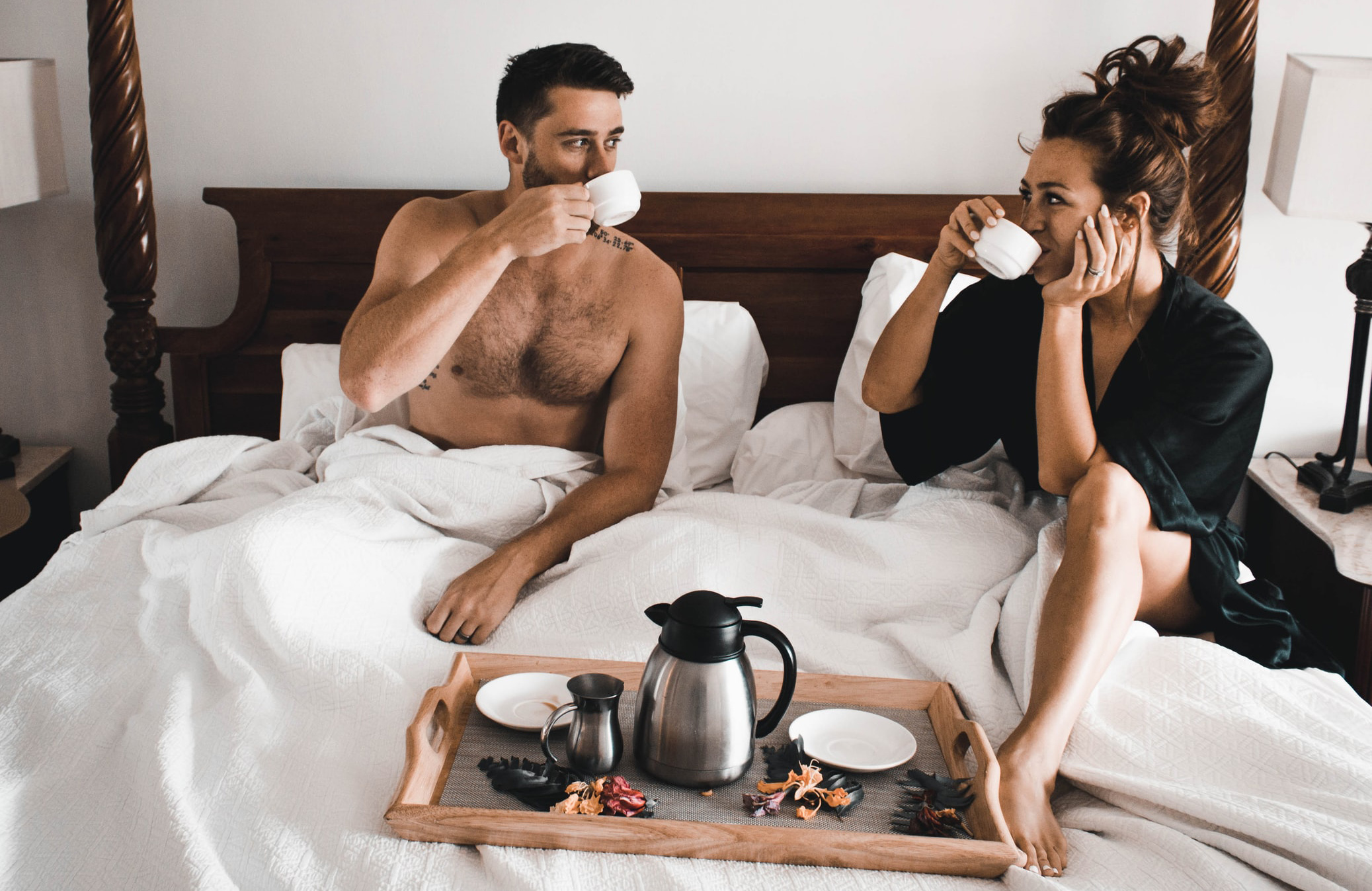 Couple having breakfast in bed, celebrating intimacy in longterm relationships