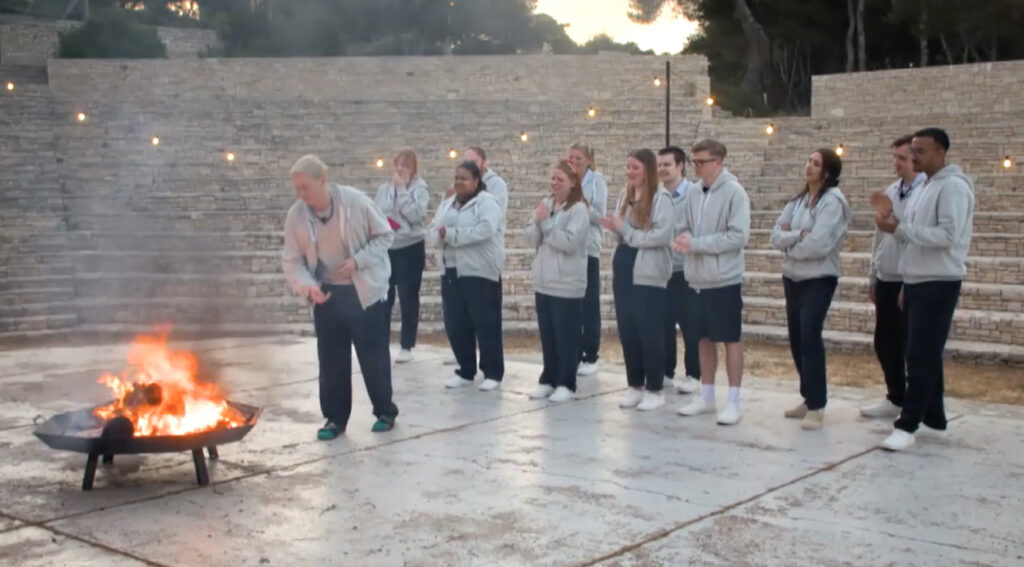 'Virgin Island' participants burning objects tied to past shame events to release their shame