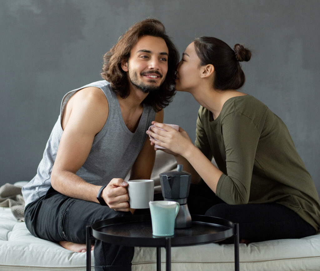 Woman whispering in her partners ear during a talk about core desires.