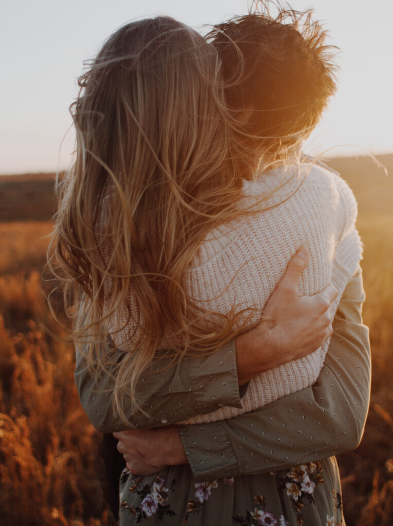Man is hugging a woman tightly, trying to understand her core wounds