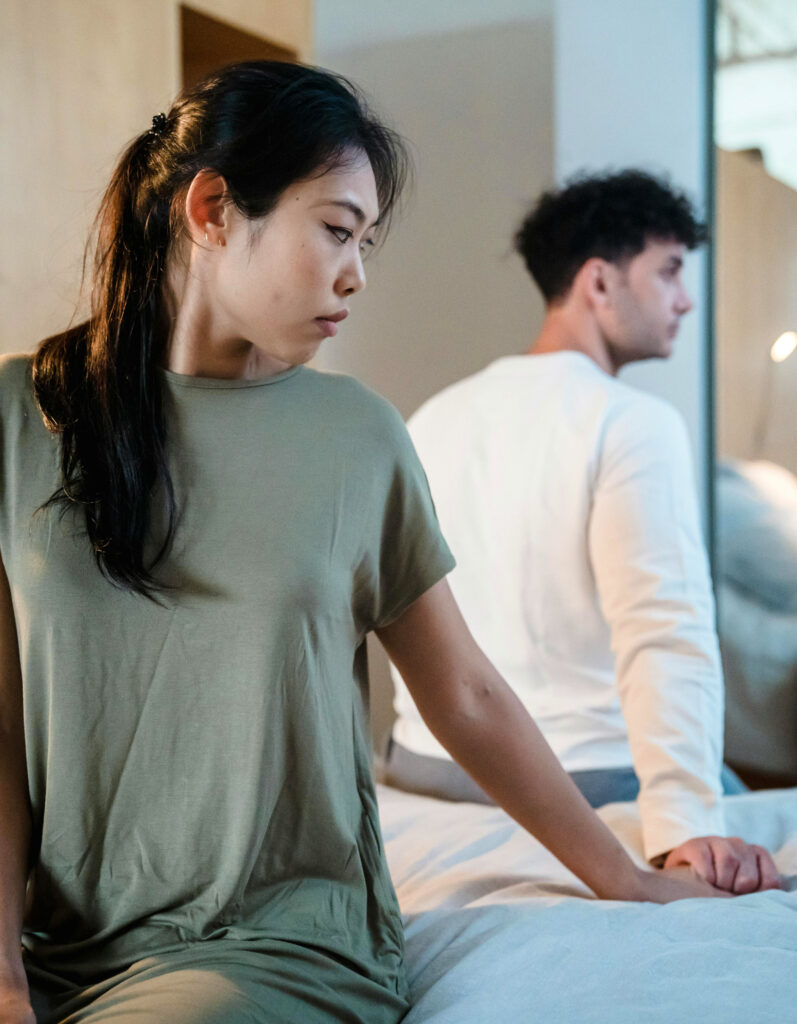 Woman holding her partners hand while turned away, thinking about her emotional self protection